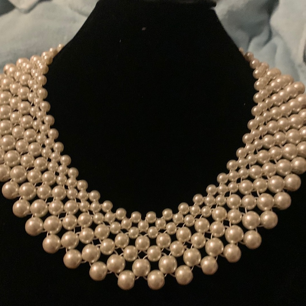 Faux pearl graduated size collar choker necklace with silver tone connector.